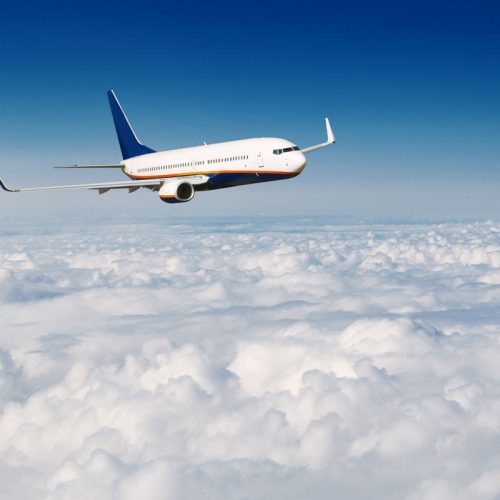 commercial-airplane-flying-above-clouds-on-blue-sk-P4ELCZZ